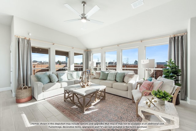 living area with plenty of natural light, vaulted ceiling, ceiling fan, and visible vents
