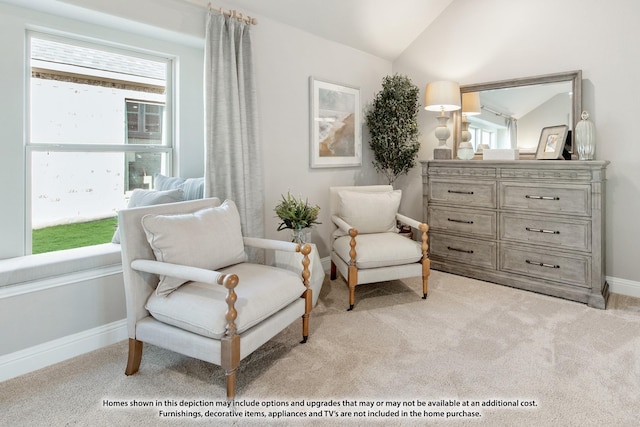 living area featuring light colored carpet, baseboards, and vaulted ceiling