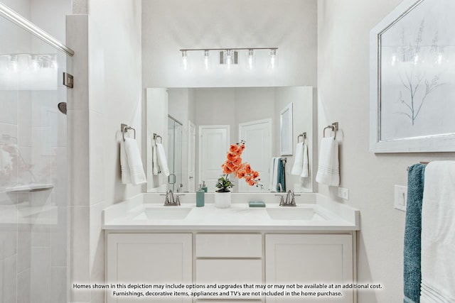 full bathroom featuring double vanity, a sink, and a stall shower