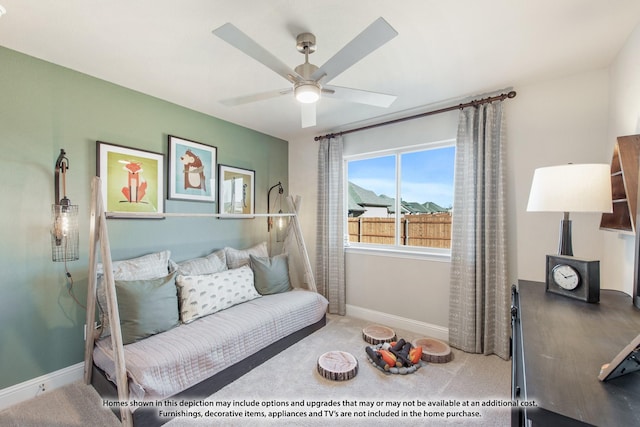 living area with baseboards, ceiling fan, and carpet