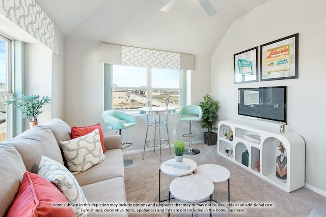 carpeted living area with ceiling fan, baseboards, and lofted ceiling