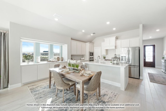 dining area featuring visible vents, lofted ceiling, baseboards, light wood-style floors, and recessed lighting
