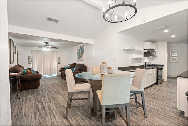 1411 Harvest Hill Ln, Arlington, TX 76014 - dining space with vaulted ceiling, visible vents, wood finished floors, and ceiling fan with notable chandelier