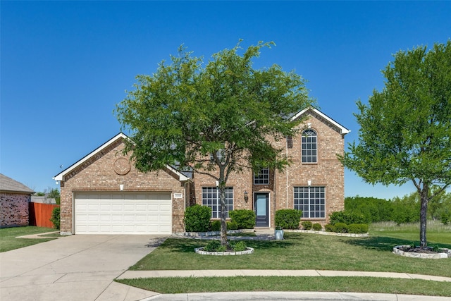 traditional-style home featuring concrete driveway, brick siding, an attached garage, and a front yard