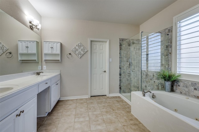 full bathroom featuring plenty of natural light, a sink, a tub with jets, and a shower stall