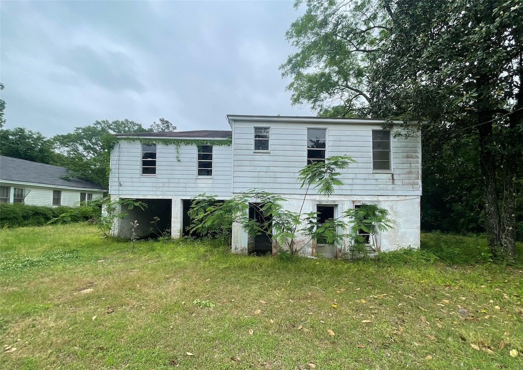 rear view of property with a yard