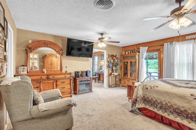 bedroom featuring visible vents, access to exterior, a textured ceiling, a ceiling fan, and carpet