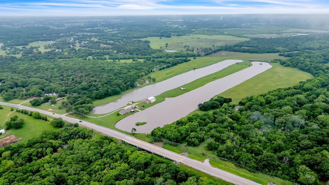 drone / aerial view featuring a water view and a forest view
