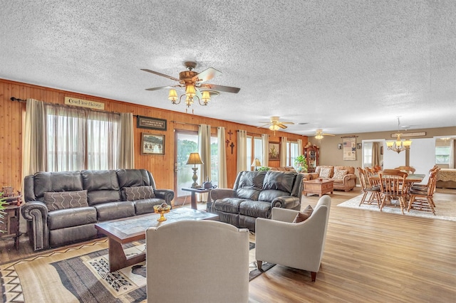 living room with a textured ceiling, wood finished floors, and a wealth of natural light