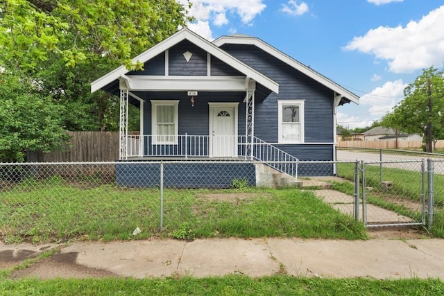bungalow-style home with a gate, a fenced front yard, and covered porch