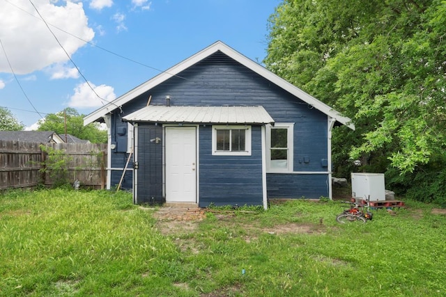 view of outbuilding featuring fence