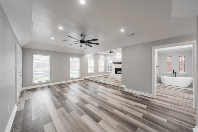unfurnished living room with recessed lighting, ceiling fan, and a wealth of natural light
