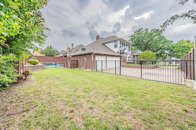 view of yard with a fenced in pool and a fenced backyard