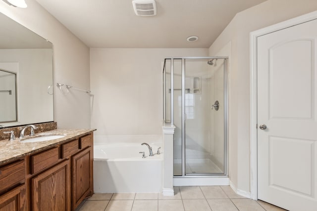 full bathroom featuring a garden tub, visible vents, a stall shower, vanity, and tile patterned floors