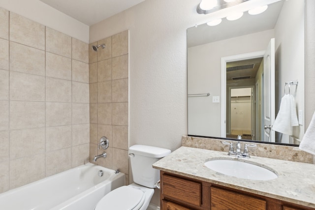 bathroom featuring vanity, bathing tub / shower combination, and toilet