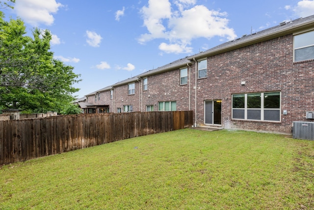 view of yard featuring a fenced backyard and central AC unit