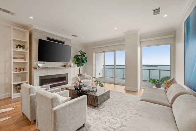2800 Lakeside Pkwy Unit 1003, Flower Mound, TX 75022 - living area featuring a fireplace, visible vents, and light wood-type flooring