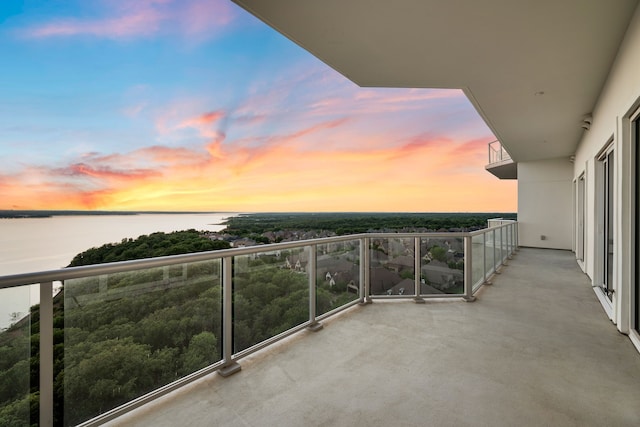 2800 Lakeside Pkwy Unit 1003, Flower Mound, TX 75022 - balcony at dusk featuring a water view