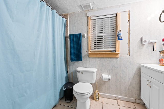 full bath with vanity, toilet, a textured ceiling, tile patterned floors, and a shower with curtain
