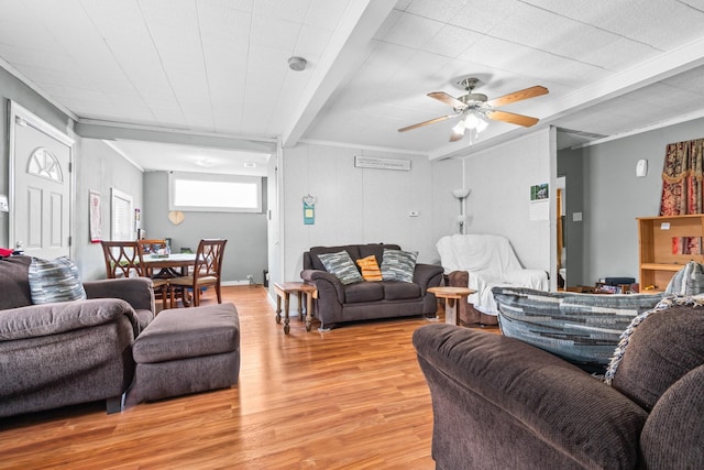 living area with ornamental molding, beamed ceiling, a ceiling fan, and light wood-style flooring
