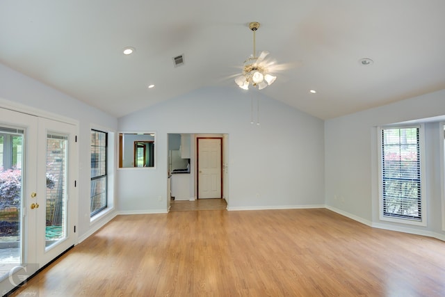 empty room with ceiling fan, french doors, visible vents, vaulted ceiling, and light wood-type flooring