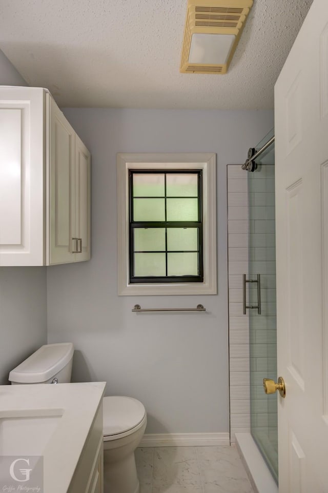 full bath with baseboards, a stall shower, toilet, and marble finish floor