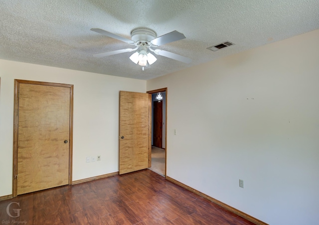 unfurnished bedroom with visible vents, wood finished floors, baseboards, a textured ceiling, and a ceiling fan