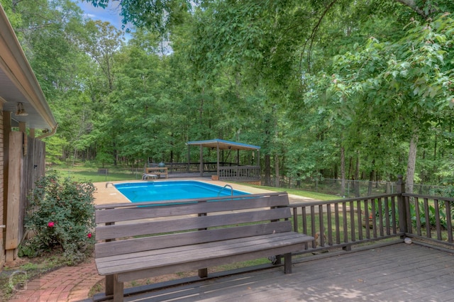 view of pool with a fenced in pool, a fenced backyard, a diving board, and a wooden deck