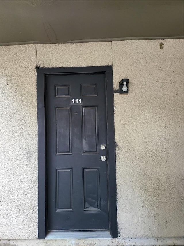 7030 Fair Oaks Ave Unit 111, Dallas, TX 75231 - property entrance featuring stucco siding