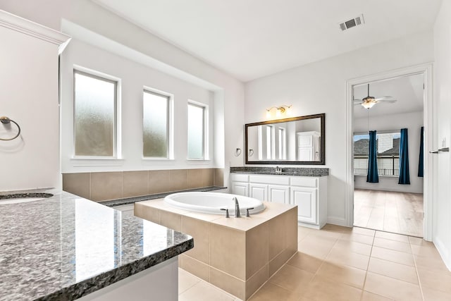 2407 Resort Dr, Heath, TX 75126 - full bath with visible vents, tile patterned floors, a bath, and a healthy amount of sunlight