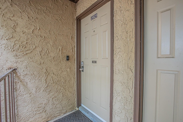 doorway to property with stucco siding