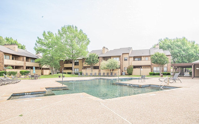 community pool with a patio area