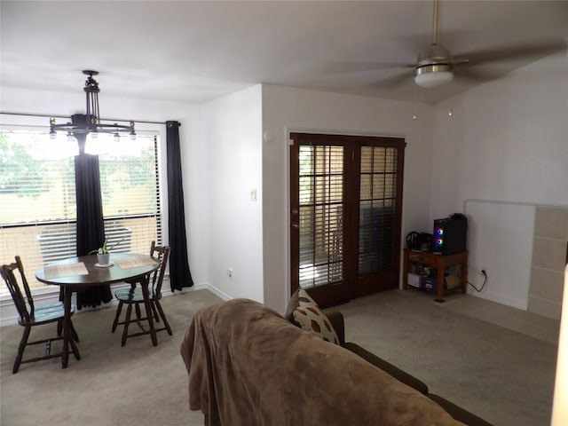 living area featuring plenty of natural light, ceiling fan, and light colored carpet