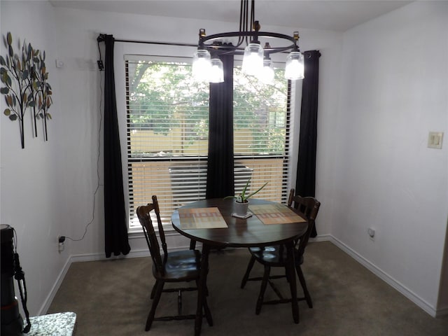 dining room with baseboards and a notable chandelier