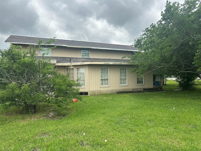 view of home's exterior with a lawn