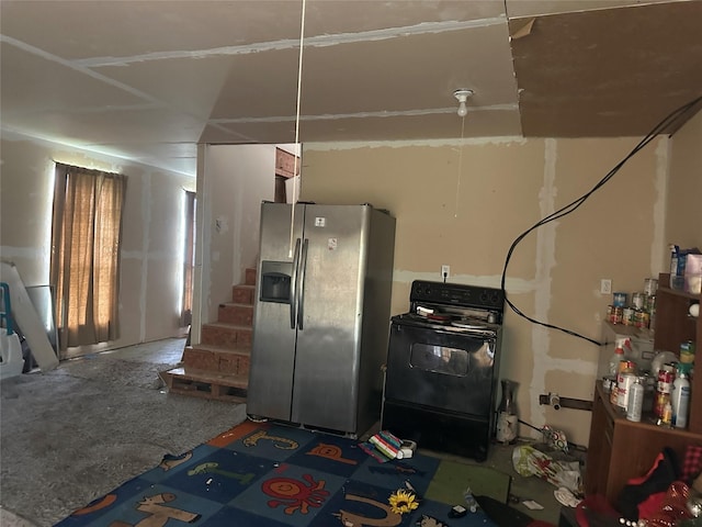 kitchen with stainless steel fridge and washer / dryer