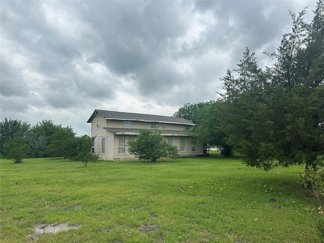 view of side of property with a lawn