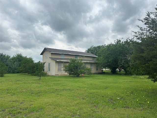 view of home's exterior with a lawn