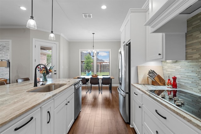 10109 Braided Briar Ln, Waco, TX 76712 - kitchen with appliances with stainless steel finishes, a sink, white cabinets, backsplash, and decorative light fixtures
