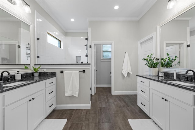 10109 Braided Briar Ln, Waco, TX 76712 - full bathroom with plenty of natural light, two vanities, walk in shower, ornamental molding, and baseboards