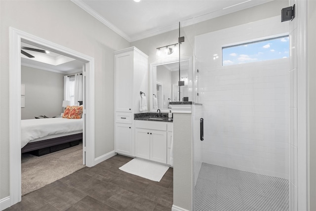ensuite bathroom featuring ensuite bathroom, ornamental molding, a stall shower, and vanity