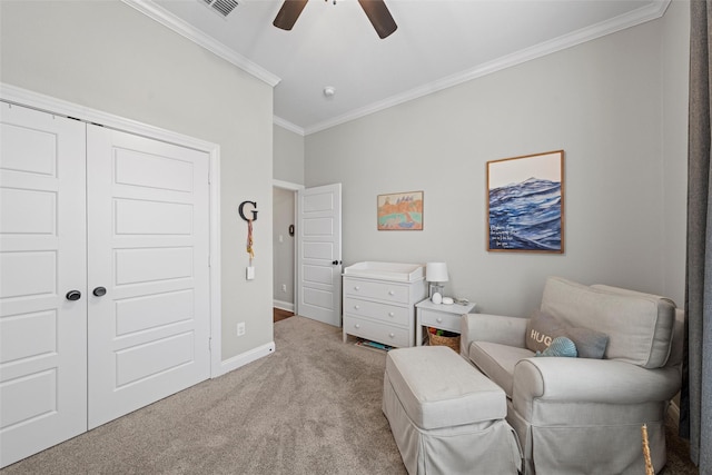 sitting room with crown molding, ceiling fan, carpet floors, baseboards, and visible vents