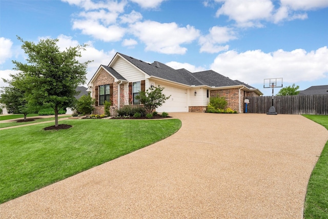 view of front of house with fence, an attached garage, a front yard, and brick siding
