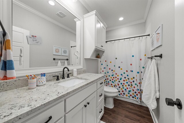 full bathroom with crown molding, toilet, wood finished floors, and vanity