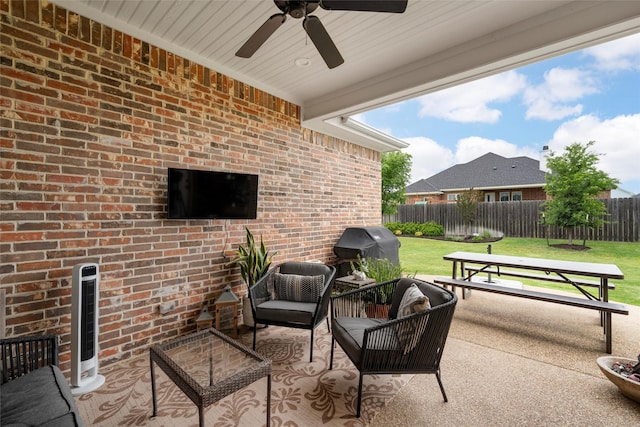 view of patio / terrace featuring fence, heating unit, ceiling fan, area for grilling, and an outdoor living space