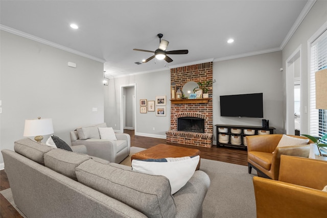 living area with crown molding, ceiling fan, and dark wood-style flooring