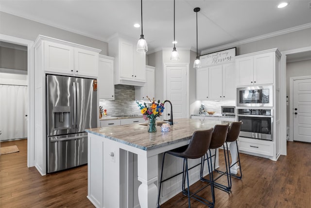kitchen featuring a sink, decorative backsplash, stainless steel appliances, and crown molding