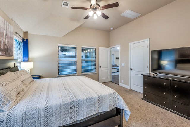 bedroom featuring light colored carpet, ceiling fan, visible vents, and vaulted ceiling