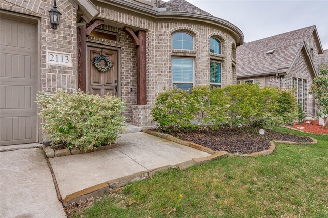 doorway to property with brick siding