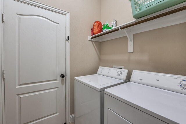 laundry area with laundry area and washer and clothes dryer